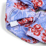 A close up of a cotton scrunchie featuring a pattern with blue and red flowers.