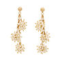 A pair of statement gold earrings featuring clusters of small white faux pearls. 
