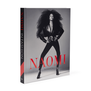 Book cover of Naomi: In Fashion. It features a black and white photo of a model dressed in black.