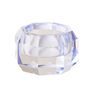 A glass tealight holder with a pale blue hue.