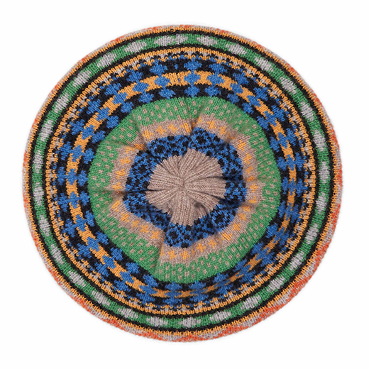 The top of a beret made of wool and featuring a striped green, yellow and blue pattern.