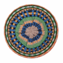 The top of a beret made of wool and featuring a striped green, yellow and blue pattern.