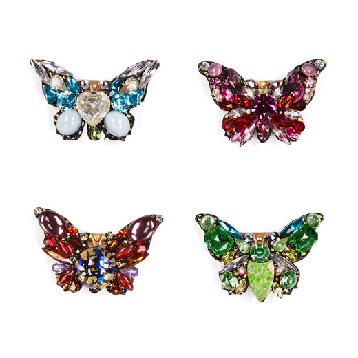 Four butterfly-shaped brooches made of colourful gleaming stones and glass beads.