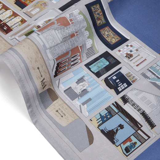 A detail of a tea towel with an illustration of the V&A museum facade. The building is sectioned to show the museums galleries and artworks.