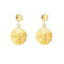 A pair of gold earrings featuring pendants in the shape of serene moon faces.