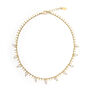 Gold necklace with white pearls.