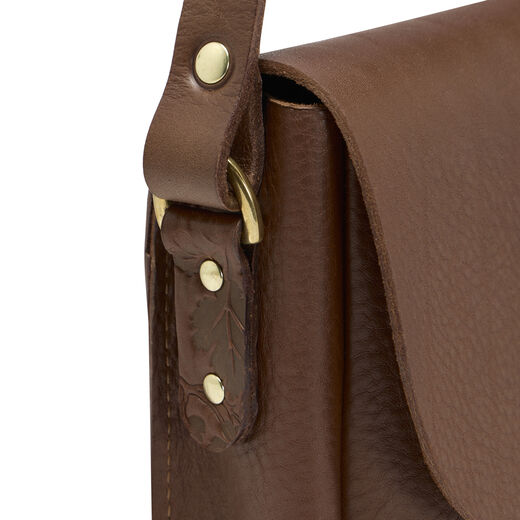 Brown leather oak-embossed saddle bag