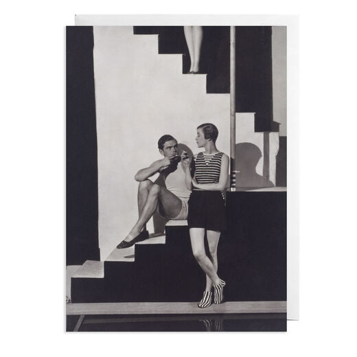 Greeting card featuring a vintage image of models wearing Schiaparelli&rsquo;s beachwear with this chic greeting card. Schiaparelli's collaborator, Bettina Jones, is captured in understated beachwear alongside a male model on a Modernist set. A subtle surreal touch is made, in the form of the disembodied mannequin legs at the top of the photograph.  Created exclusively to accompany the Schiaparelli: Fashion Becomes Art exhibition, the card is made from premium, responsibly sourced paper and is blank inside for your own message shoot by Schiaparelli George Hoyningen-Huene