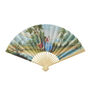 Paper hand fan featuring a reproduction of a painting depicting two lovers court dresses sittingin a idyllic landscape.