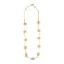 A long gold necklace with clusters of white faux pearls imitating flowers.