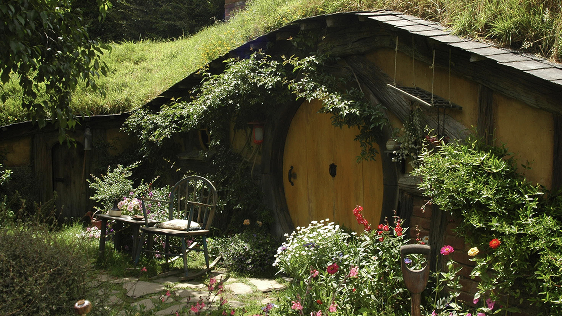 Brown and black wooden house with garden of hobbit movie set