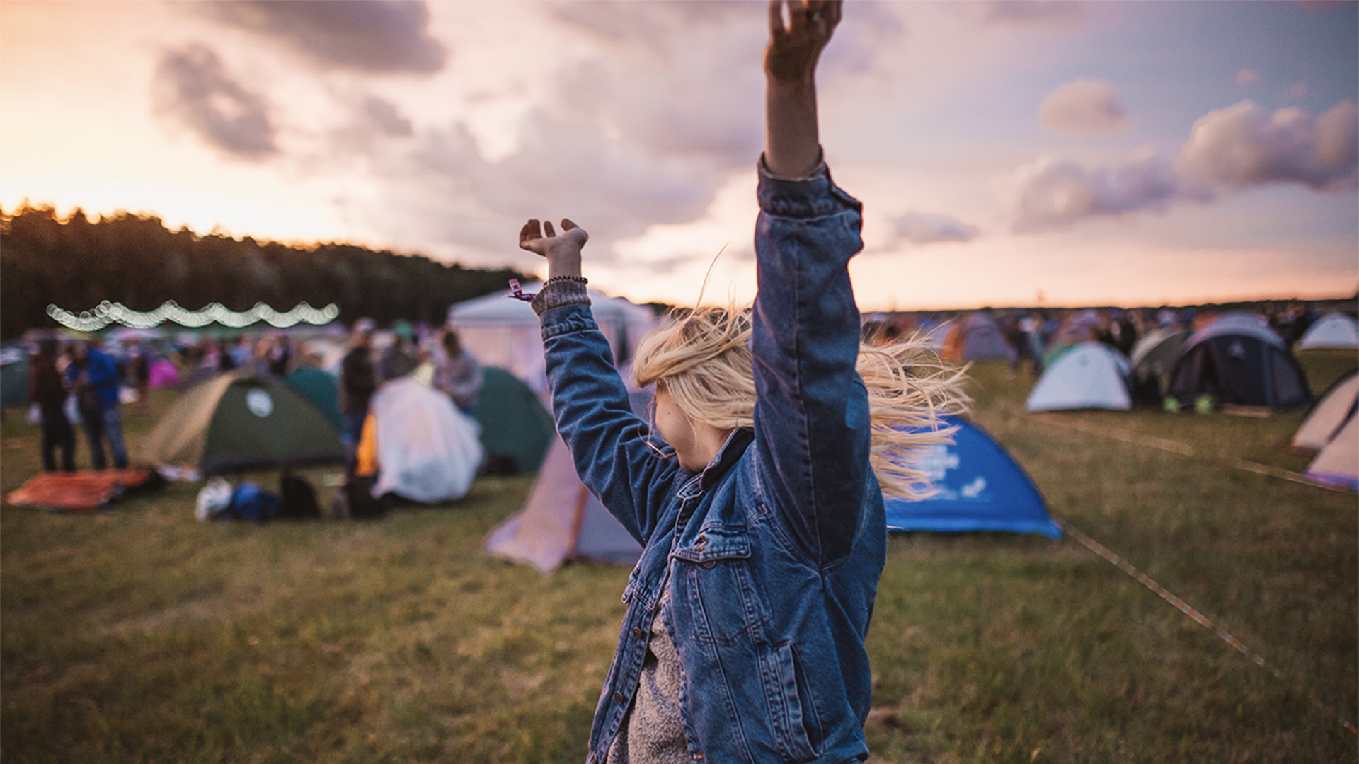 A person dancing on a campsite