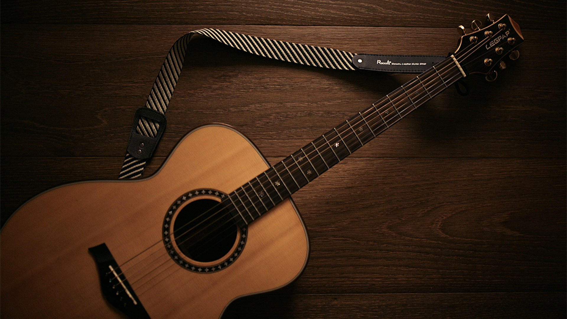 Acoustic guitar on a wooden background