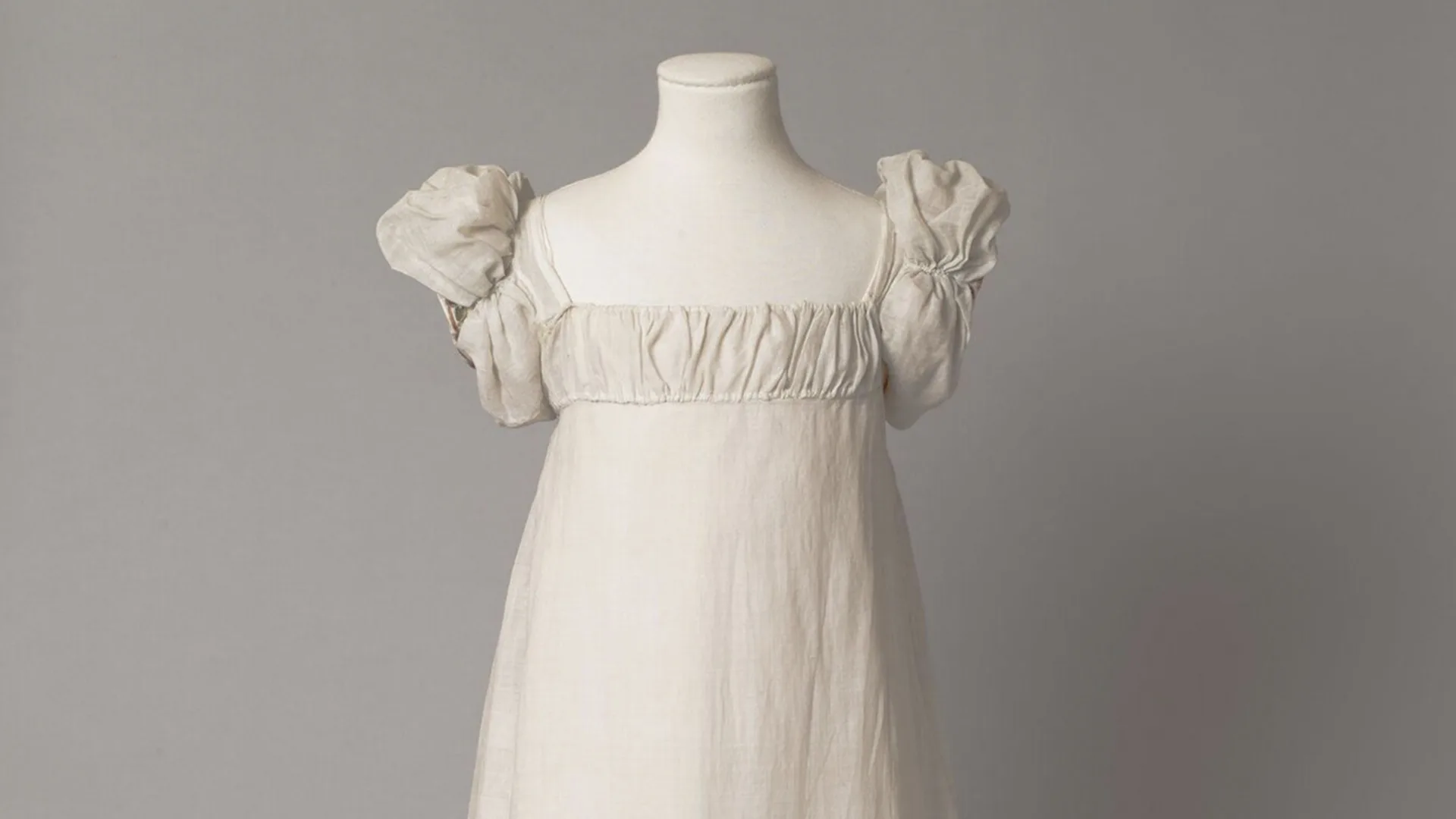 Regency style white muslin dress with floral pattern