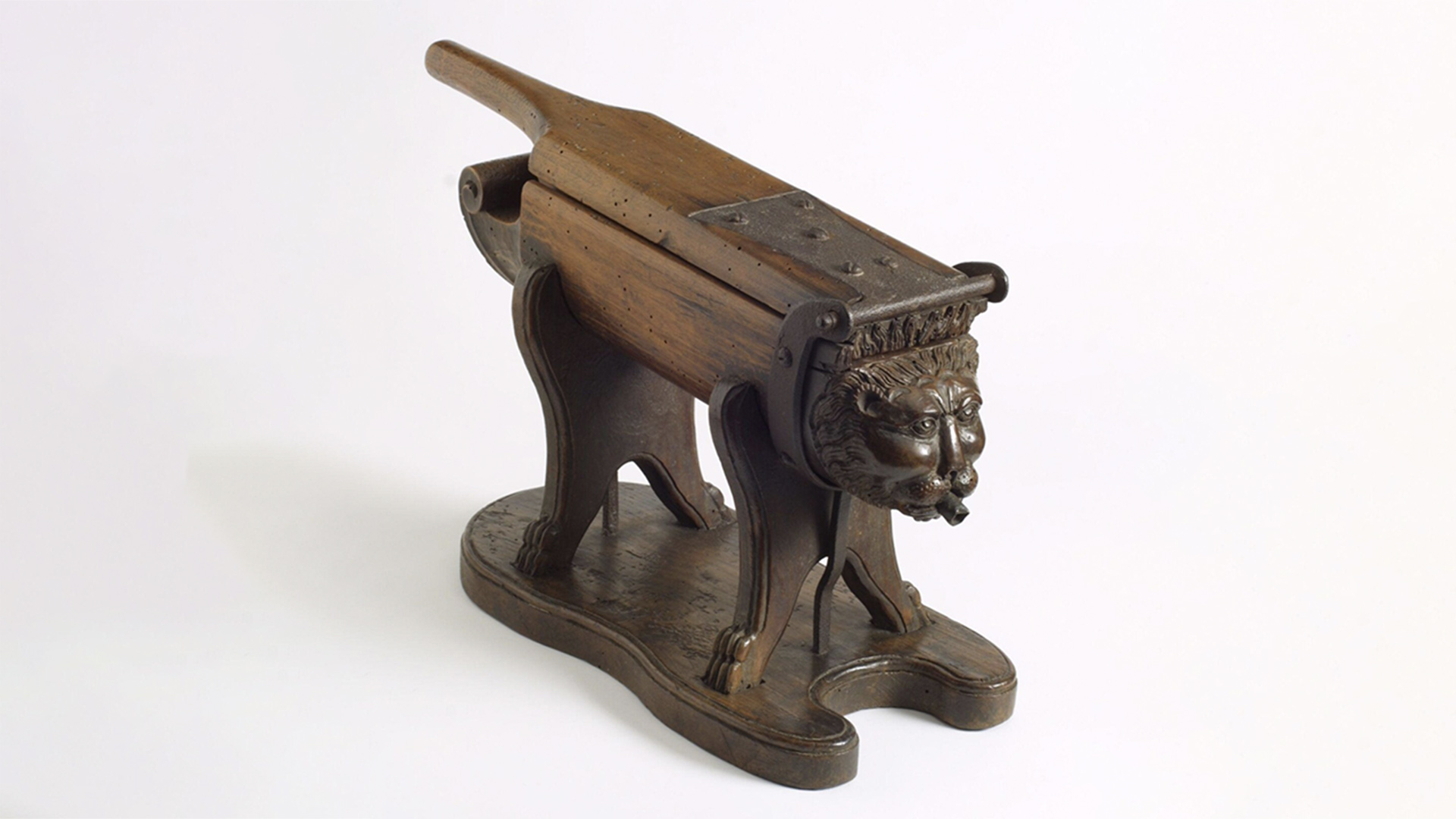 Wooden lion with a flat hinged handle on top
