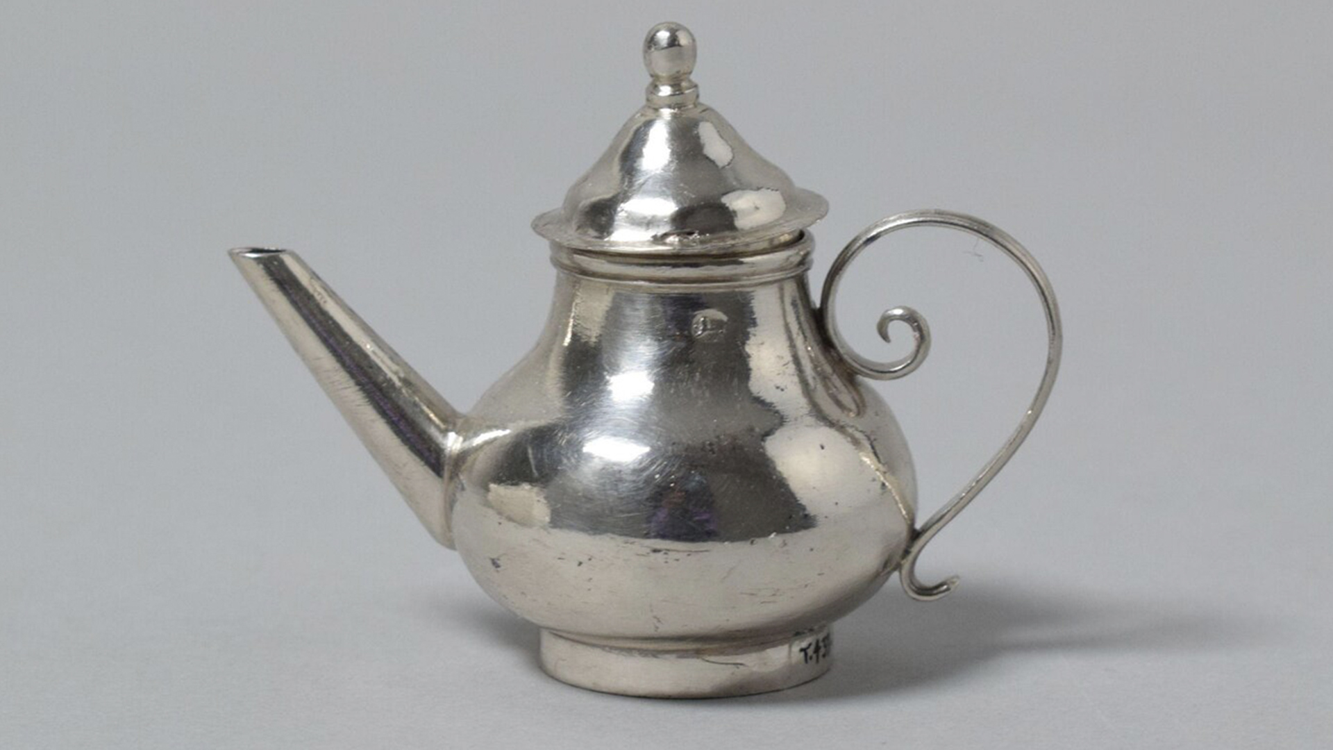Toy silver teapot with cover