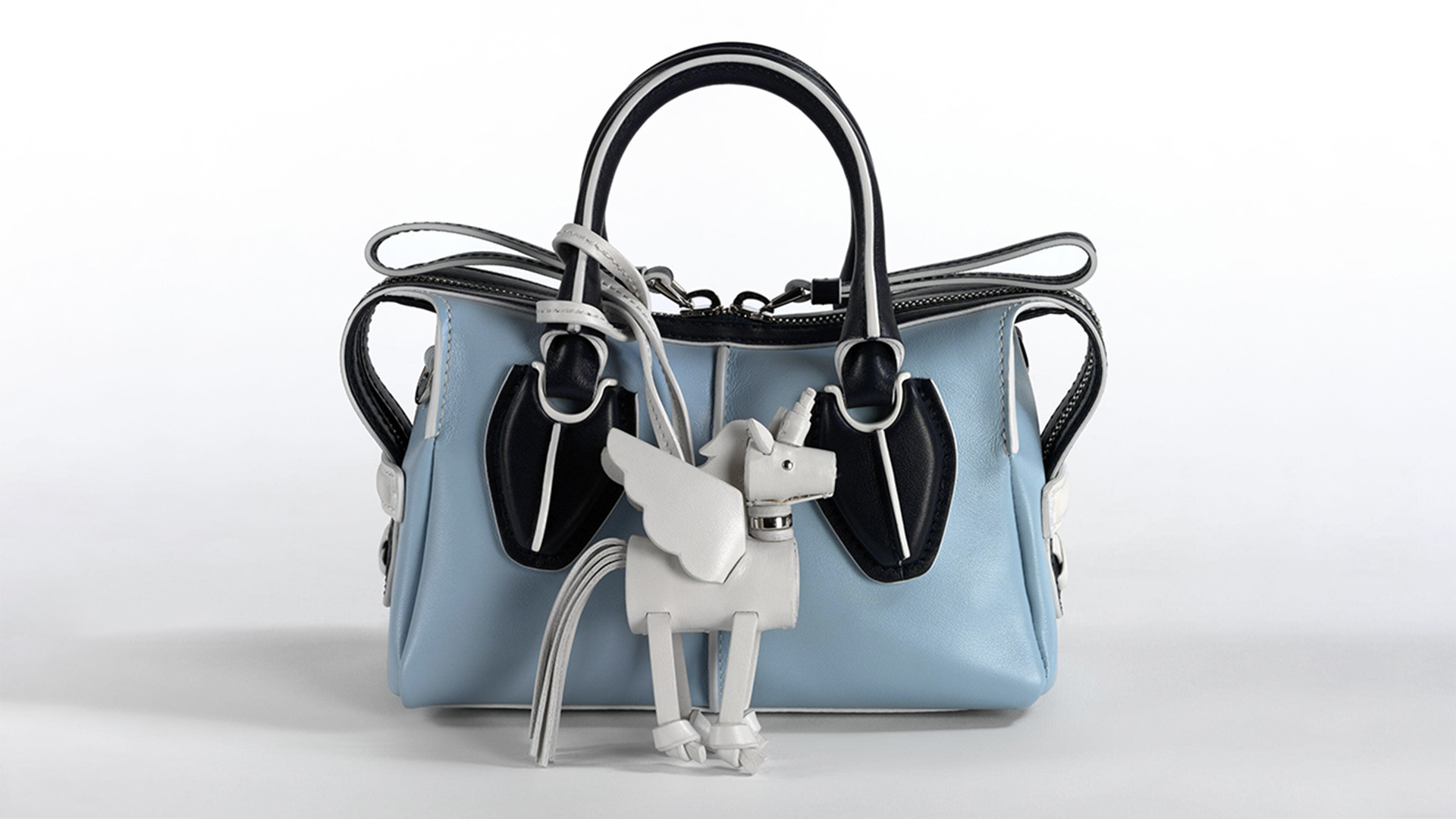 Blue leather handbag with a detachable white unicorn