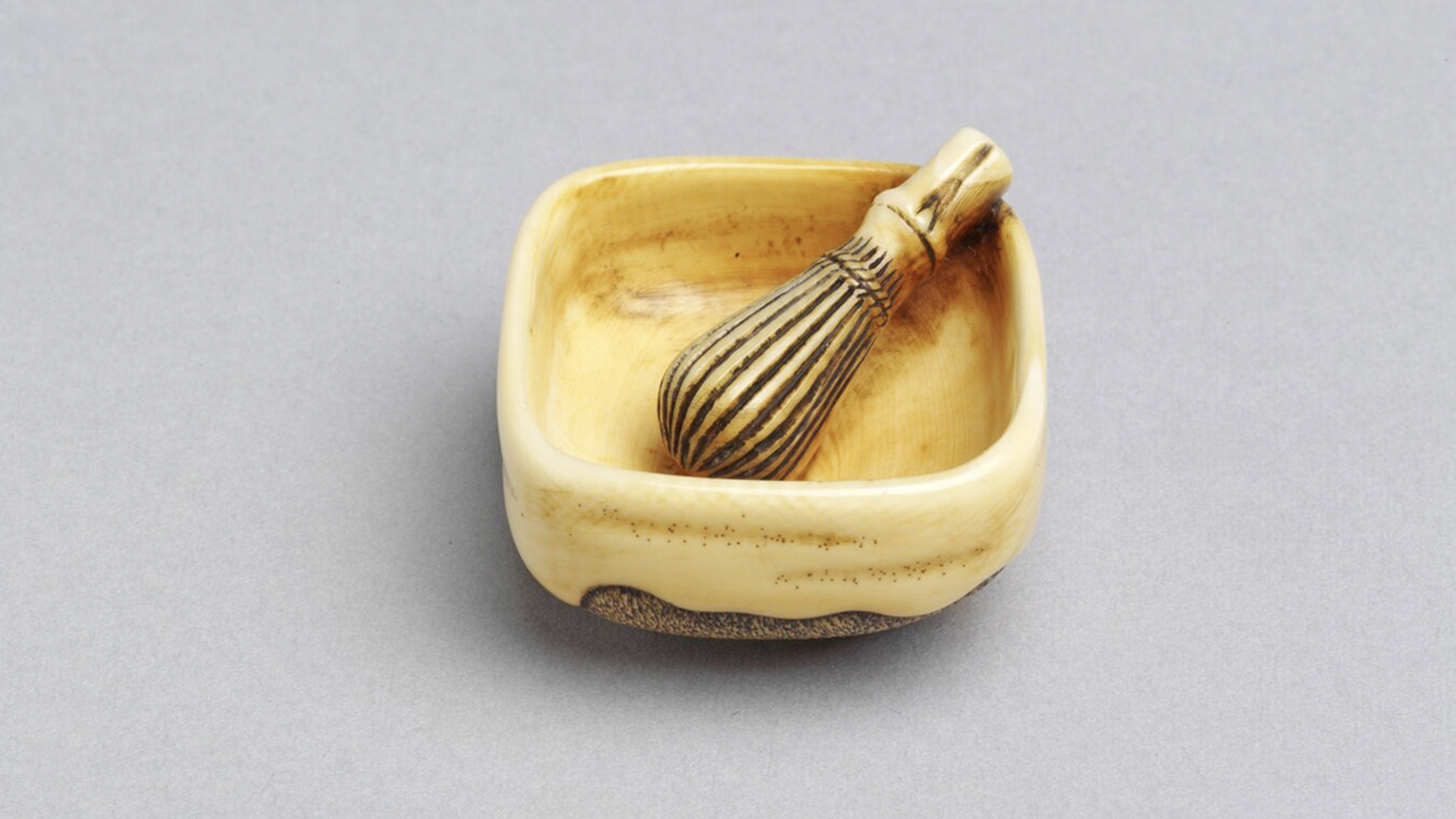 Miniature ivory carving of a tea bowl and whisk