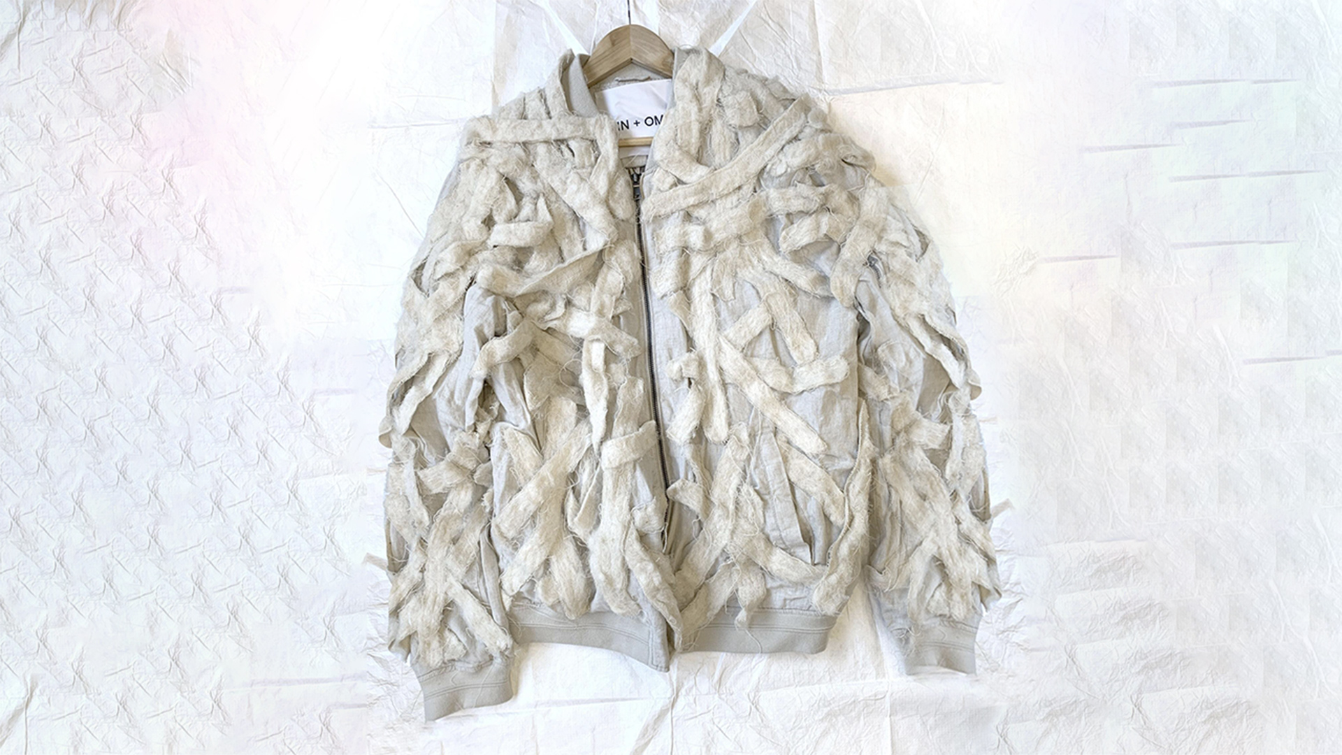 White jacket decorated with plant fibres