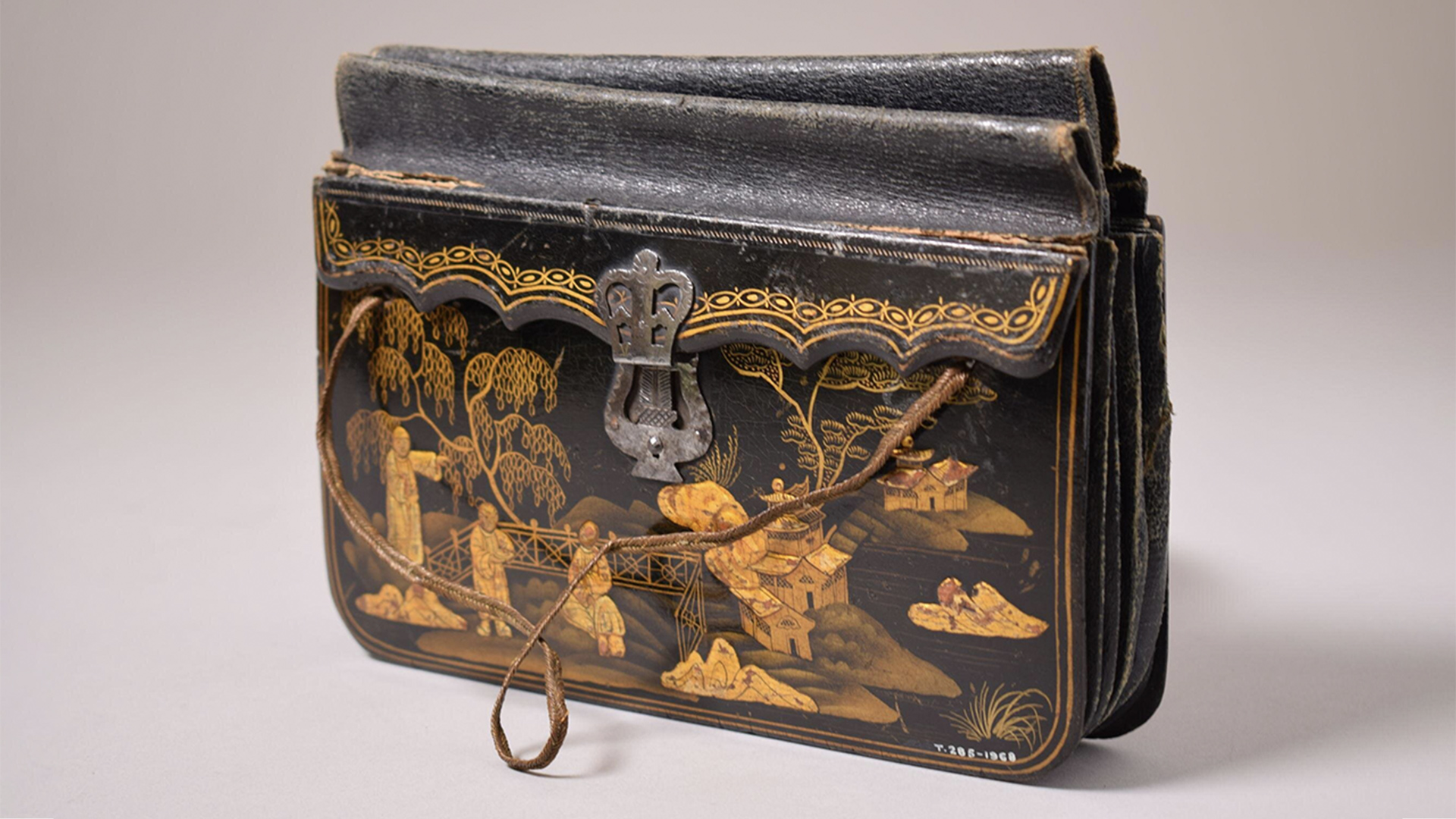 Black leather handbag with a garden in gold