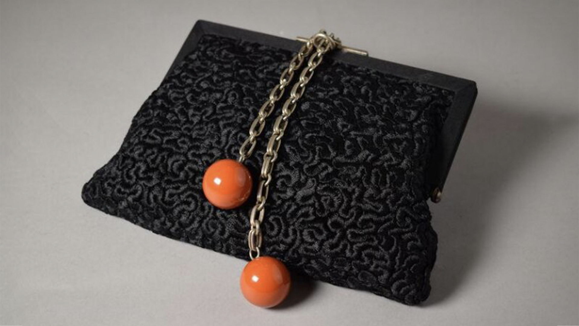 Black silk handbag with red amber balls