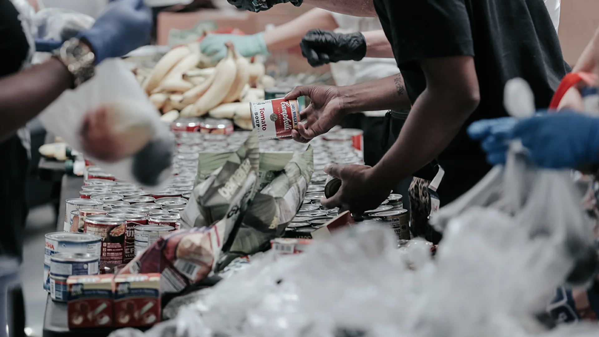 People giving out food to those in need at a food bank