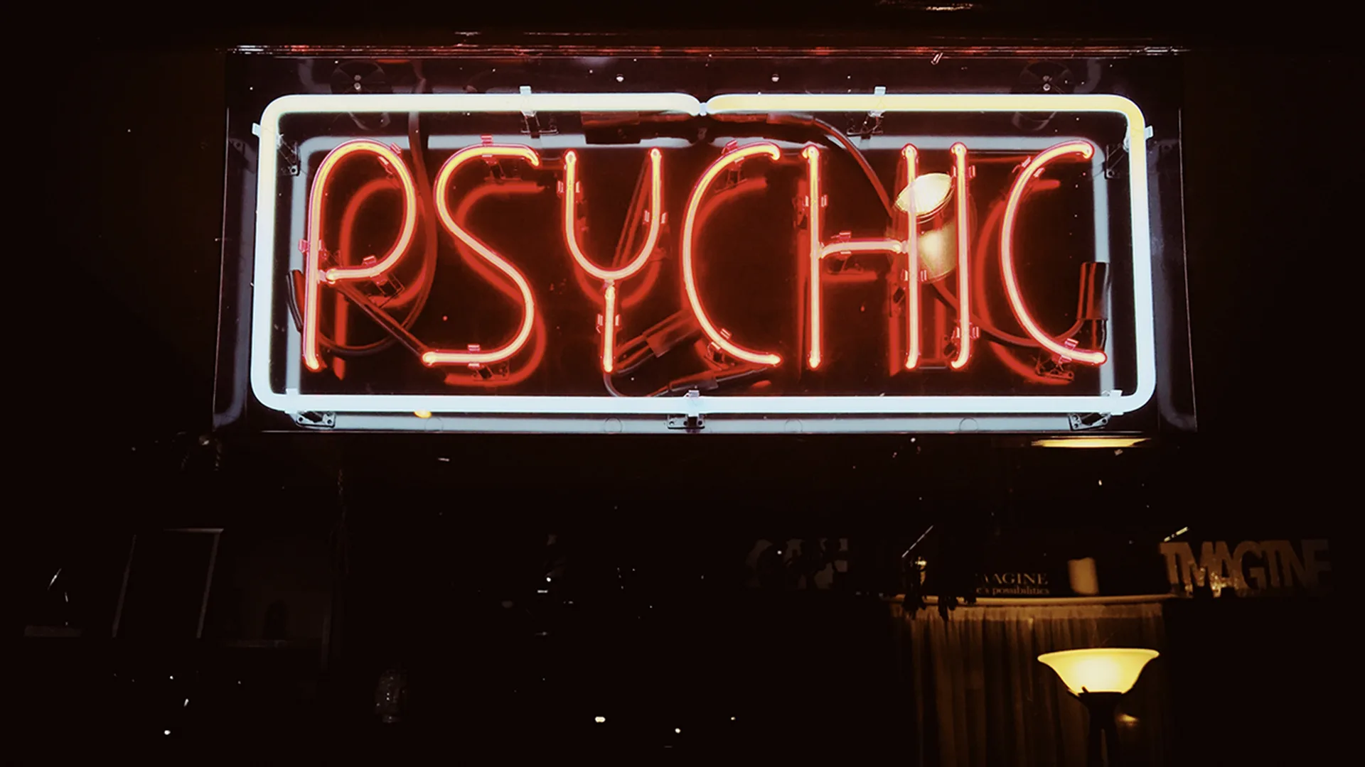 A red neon sign that reads PSYCHIC