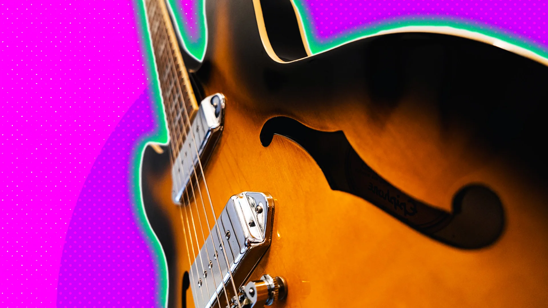 Close up of a guitar at a sharp angle with a polkadot background and a glow around the image