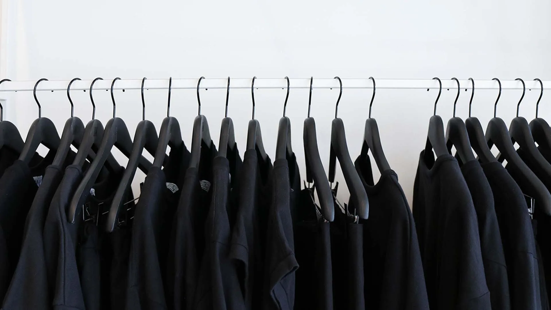 A rack of black t-shirts