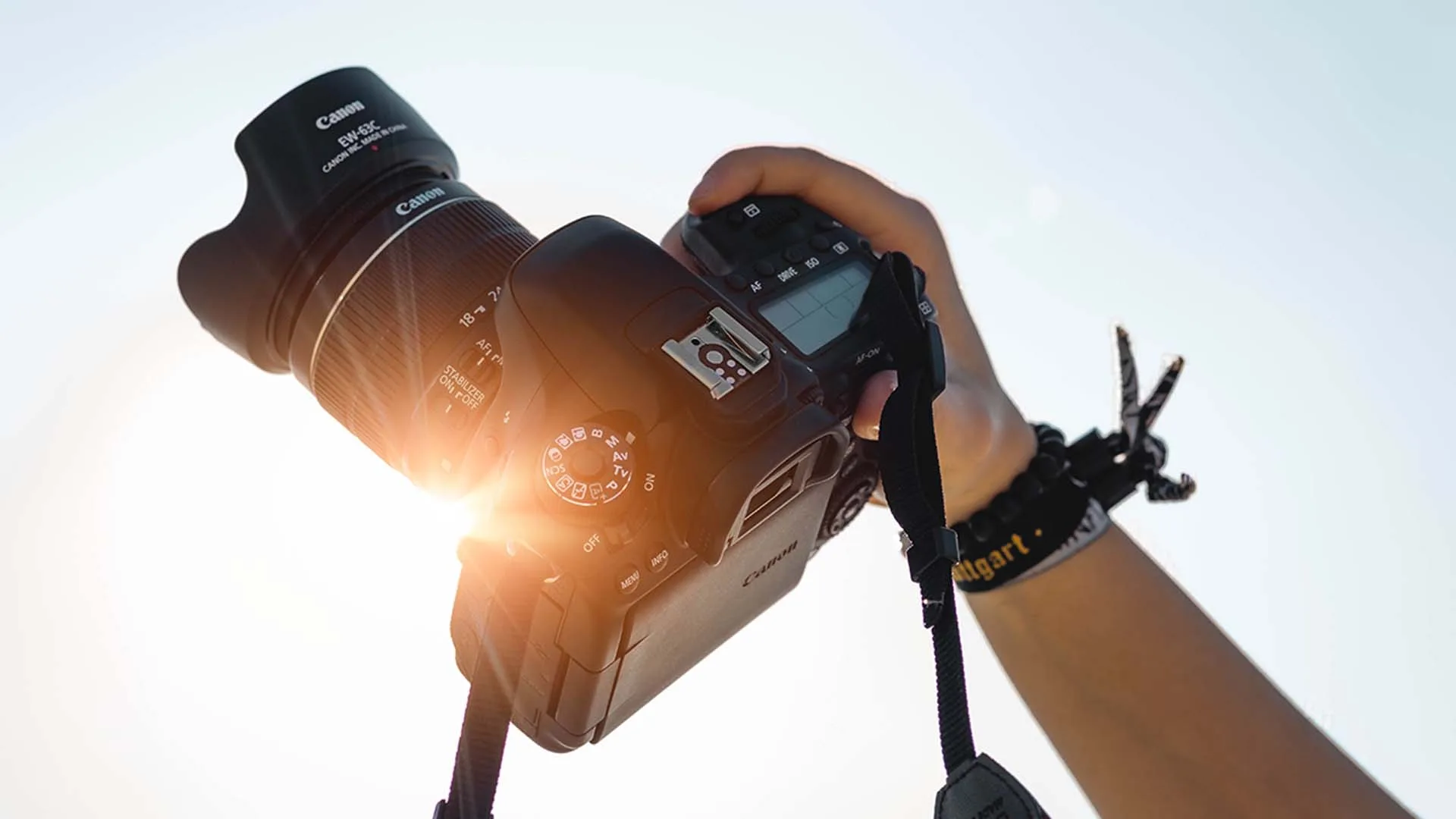A camera held up with the sun behind it