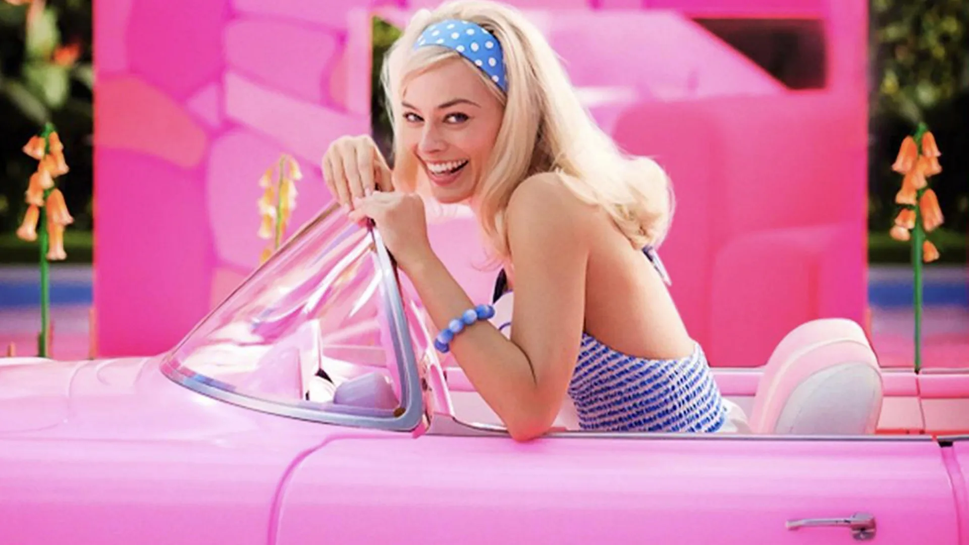 Stereotypical Barbie sat in her pink car