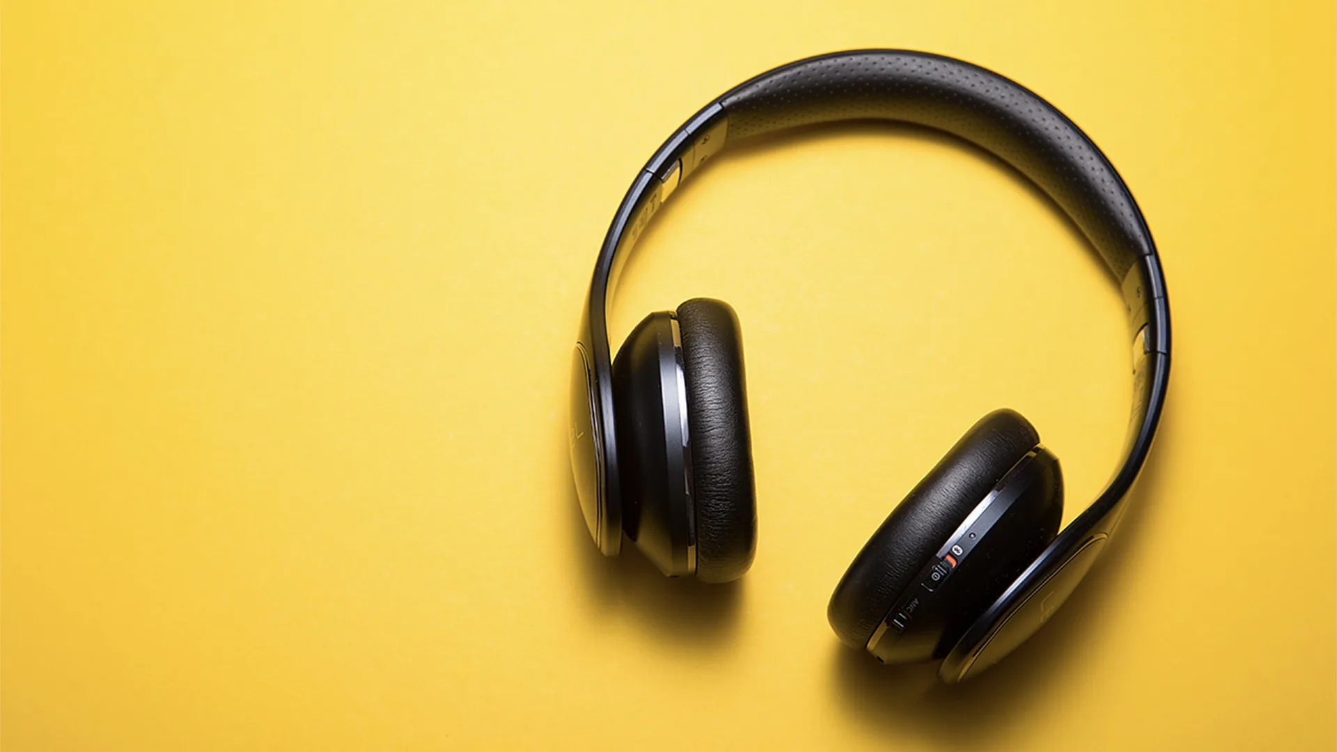 Wireless headphones on a yellow background