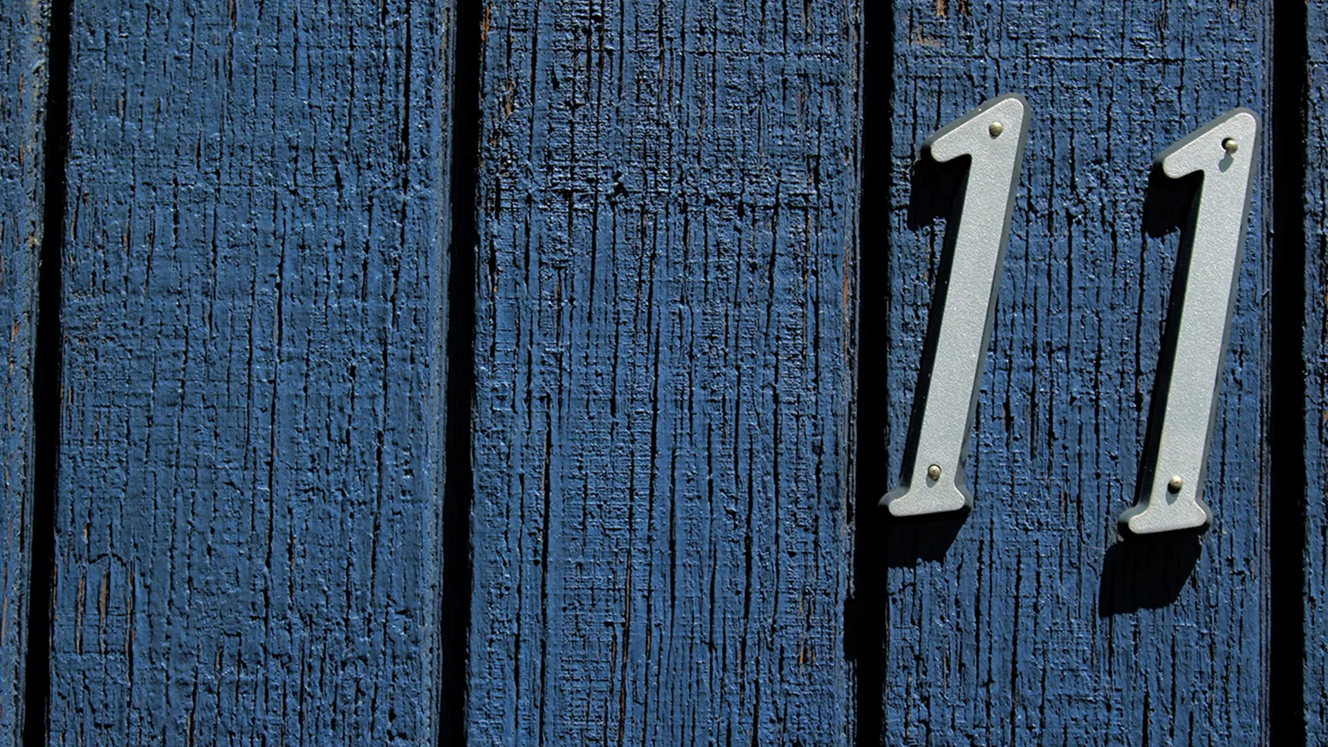 The number 11 on some blue wood