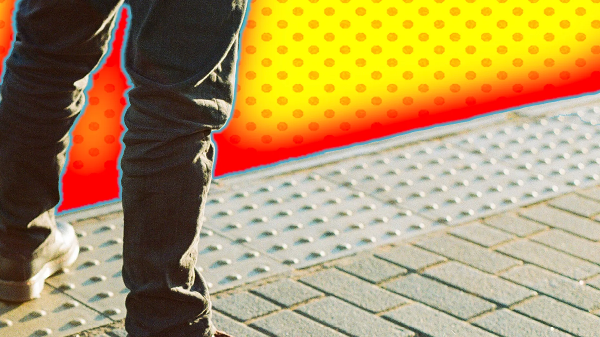 Close up of a man standing on a bumpy pavement with a yellow footed background outlined by a red glow effect