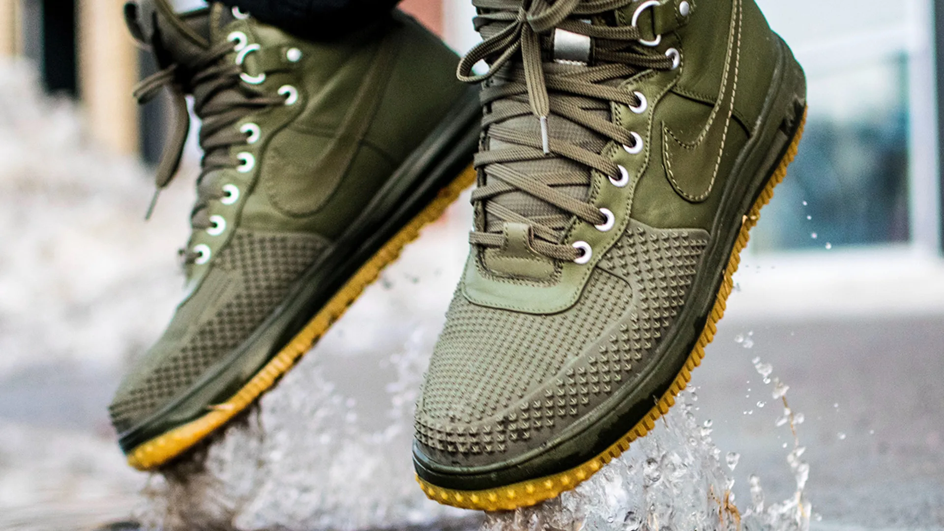 Green Nike hiking boots in a puddle