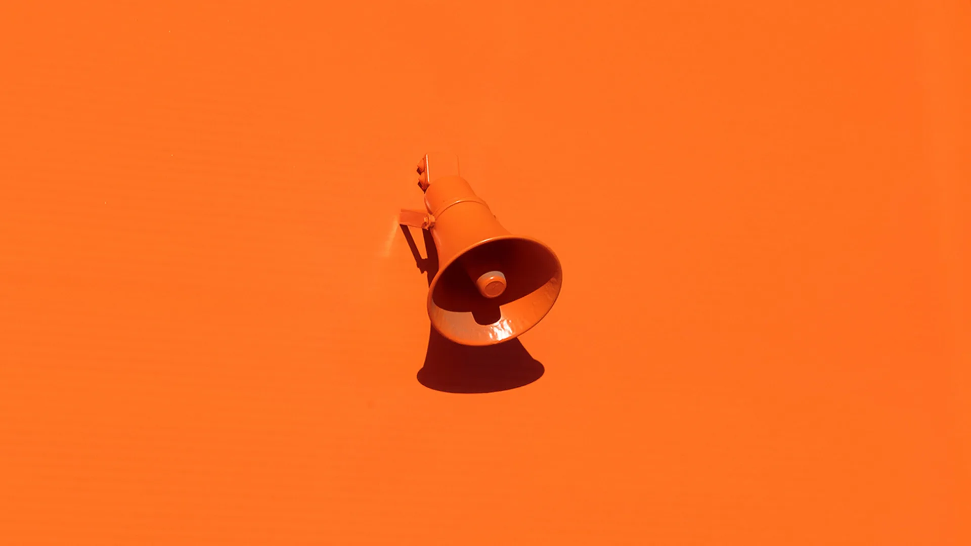 A orange speaker on an orange background