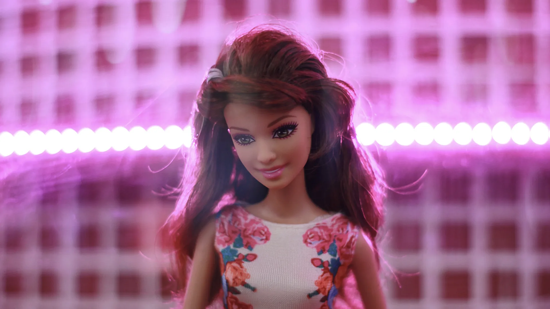 Toy Barbie on a pink lit up background
