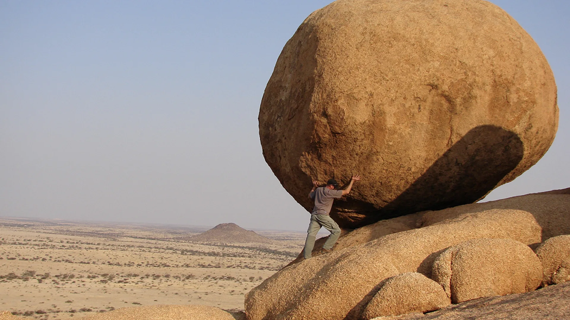 Person pushing a rock
