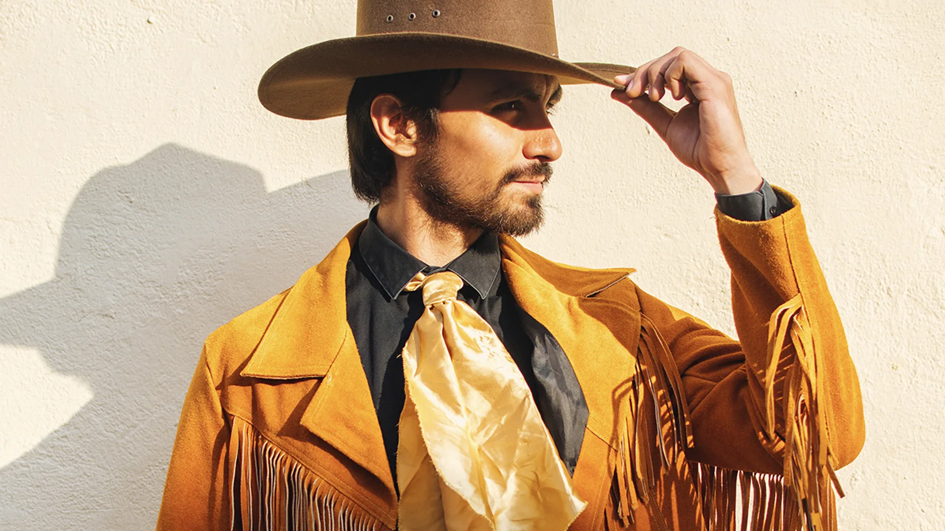 A man dressed with a tan brown jacket