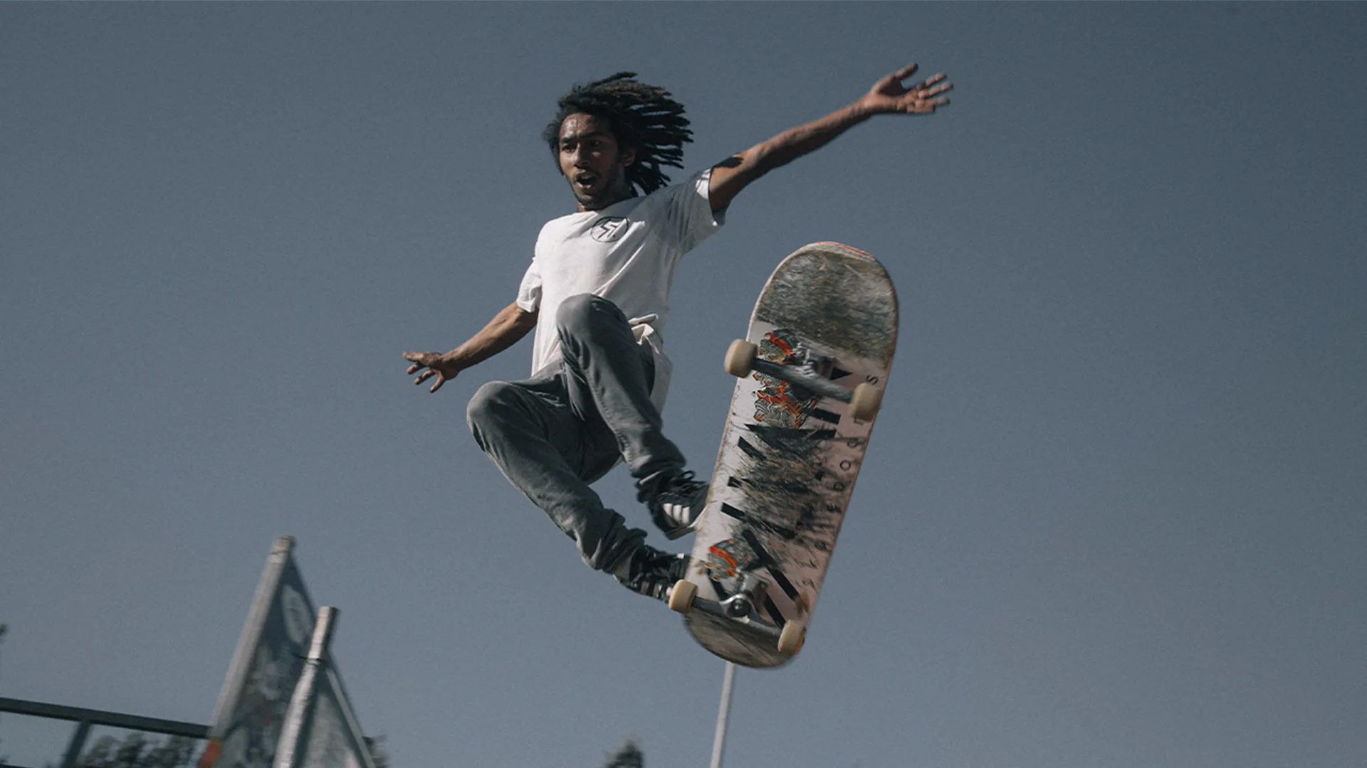 A man skating and failing off midair