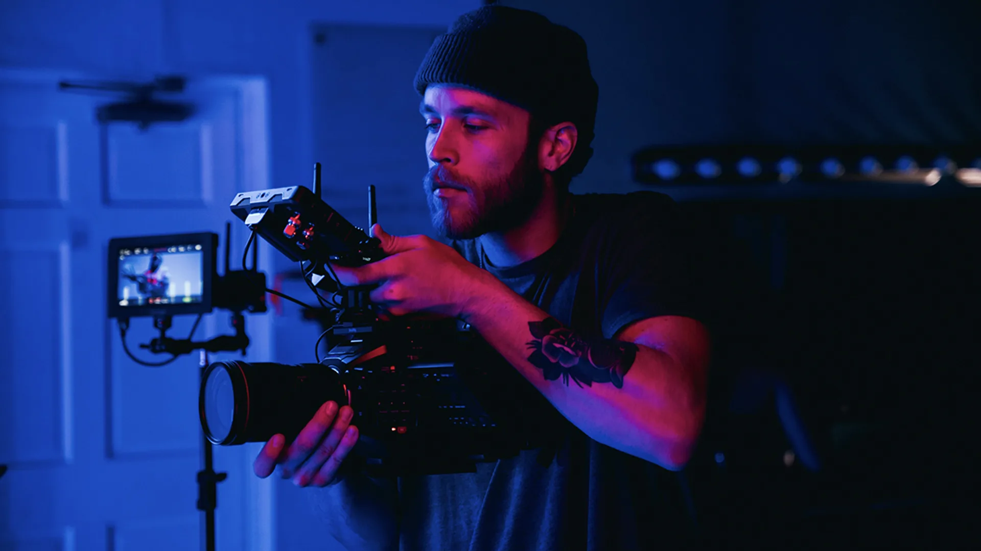 man in black t-shirt holding video camera