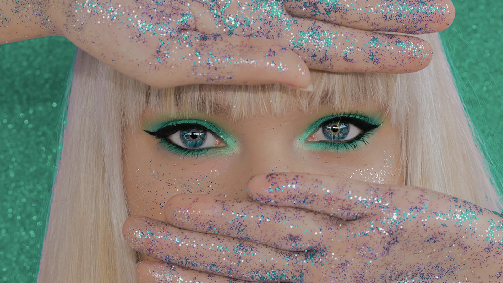 A woman with blonde hair and glitter on hands