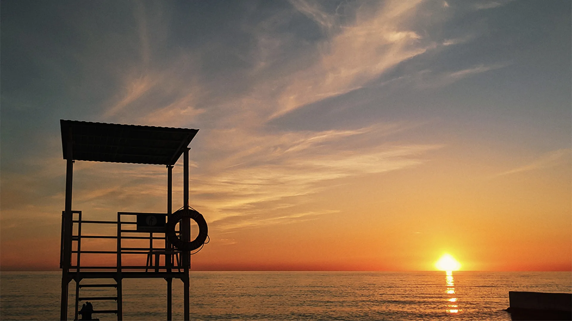 A beach with a lifeguard post