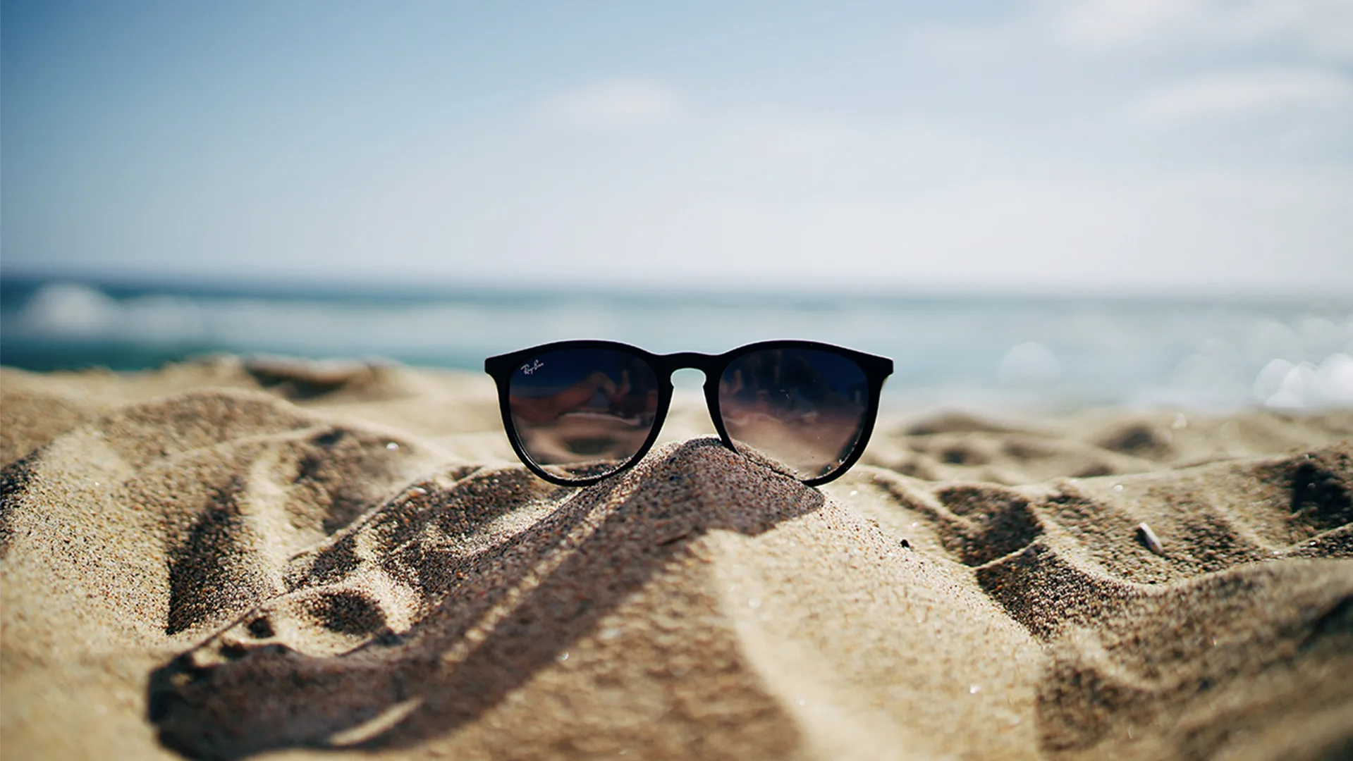Suglasses on the sand of a beach