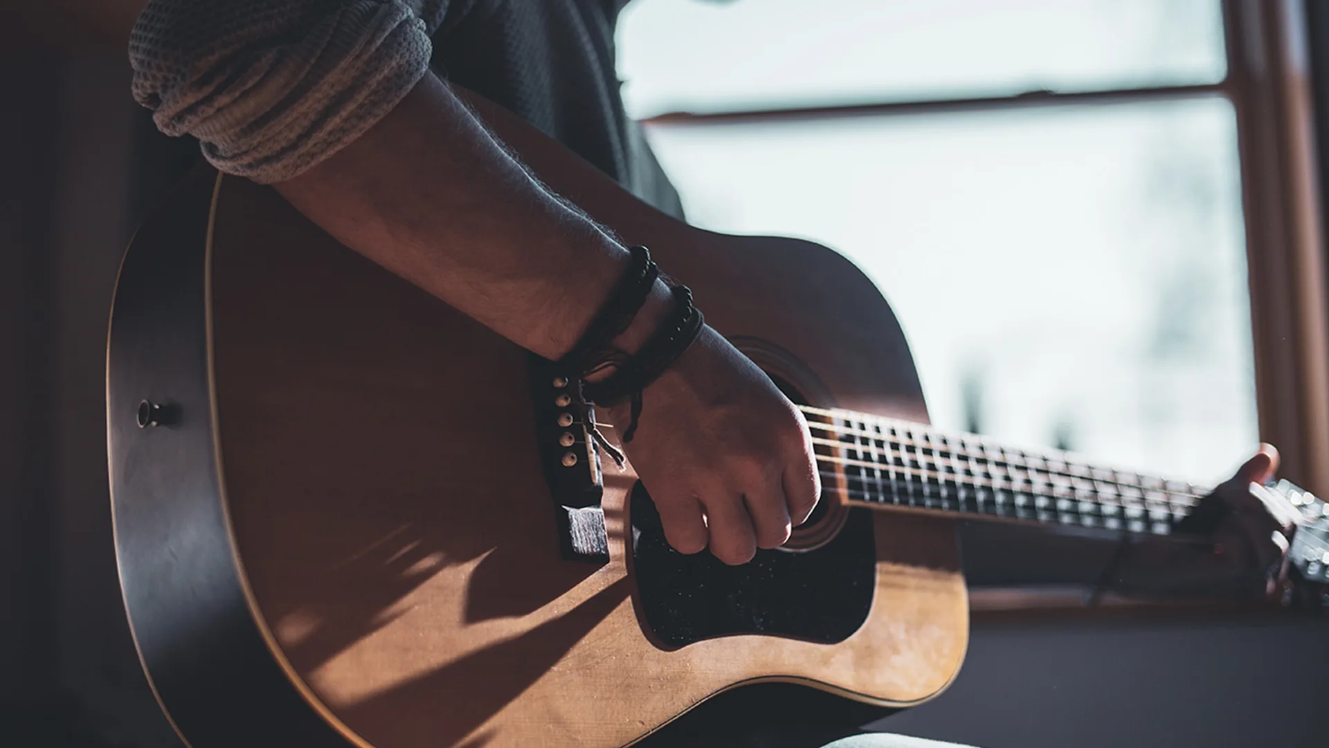 Someone playing an acoustic guitar