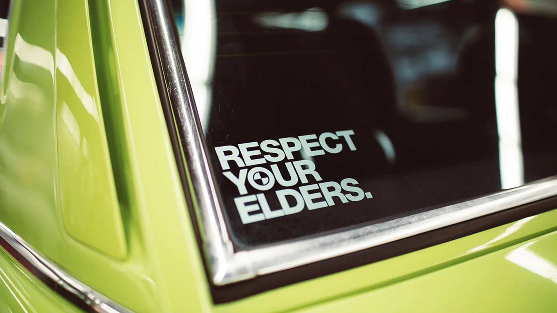 A car with a sign saying respect your elders