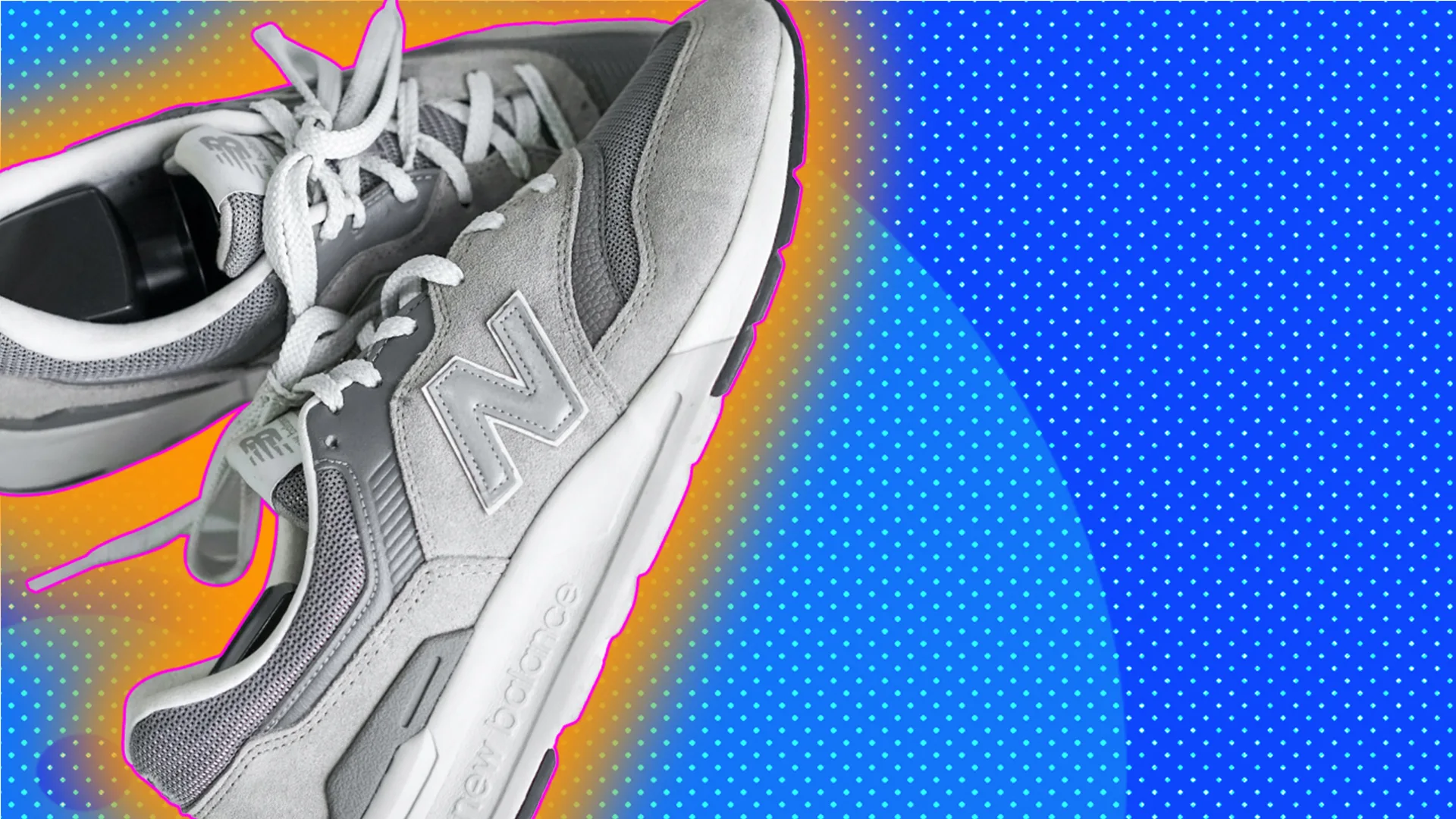 Grey New Balance trainers, outlined by orange halo effect on blue-dotted background.