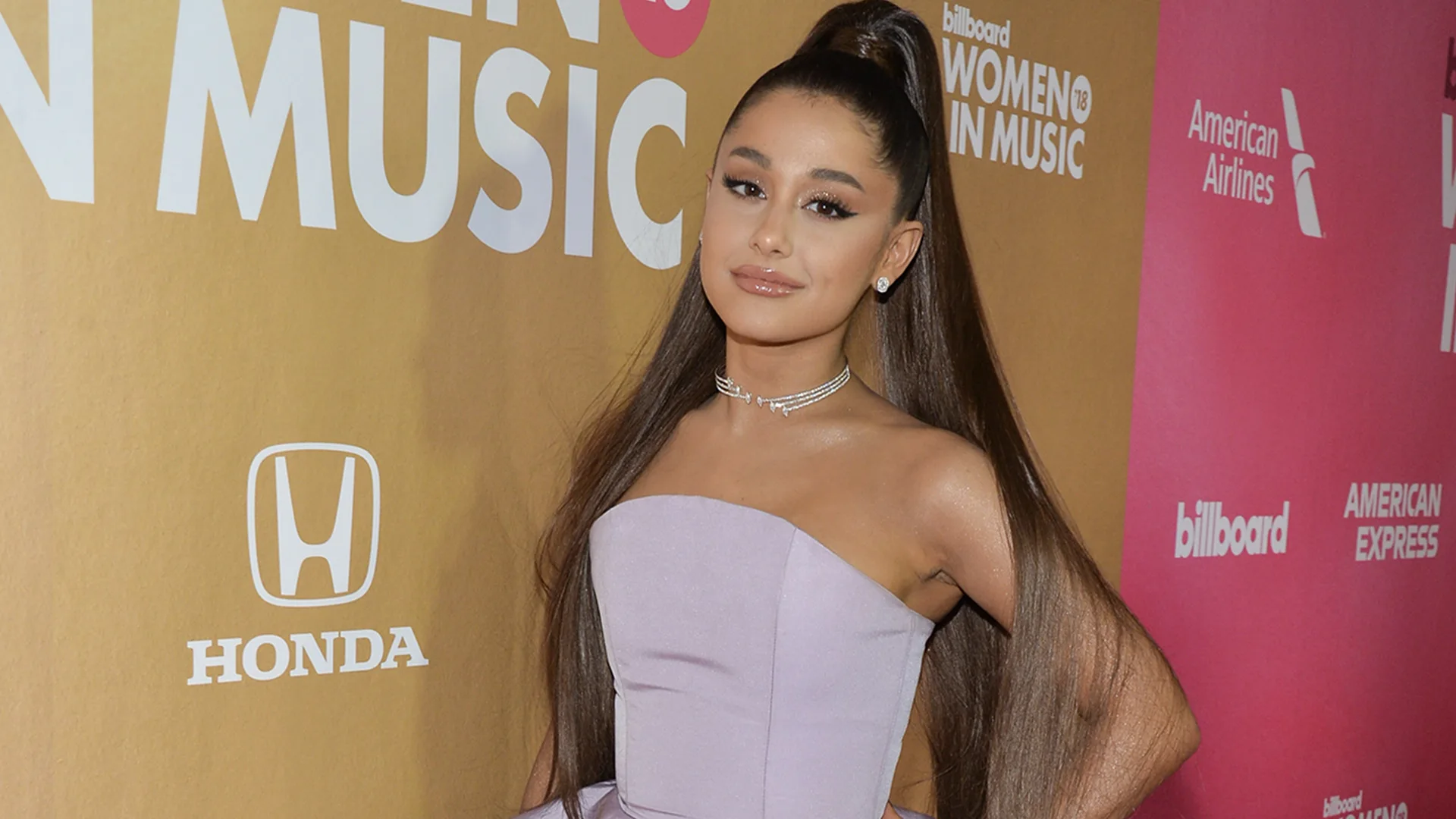 Ariana Grande wearing purple dress at an awards ceremony