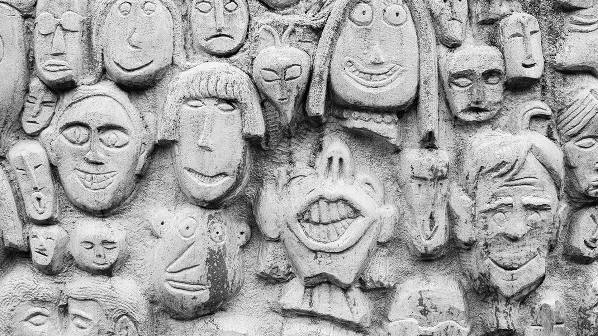 Smiling faces carved into concrete wall