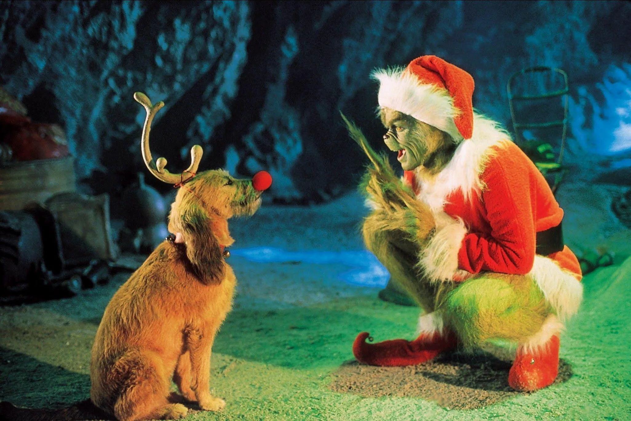 Grinch from the film crouching next to the Grinch dog